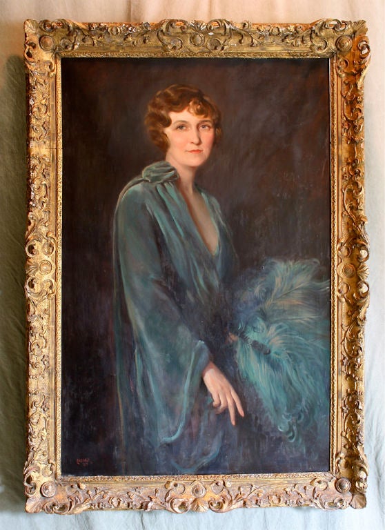 A large art deco period portrait of Mrs. Helen Page Echols wearing a green velvet gown with matching ostrich plume fan in an elaborately carved giltwood frame, signed and dated.