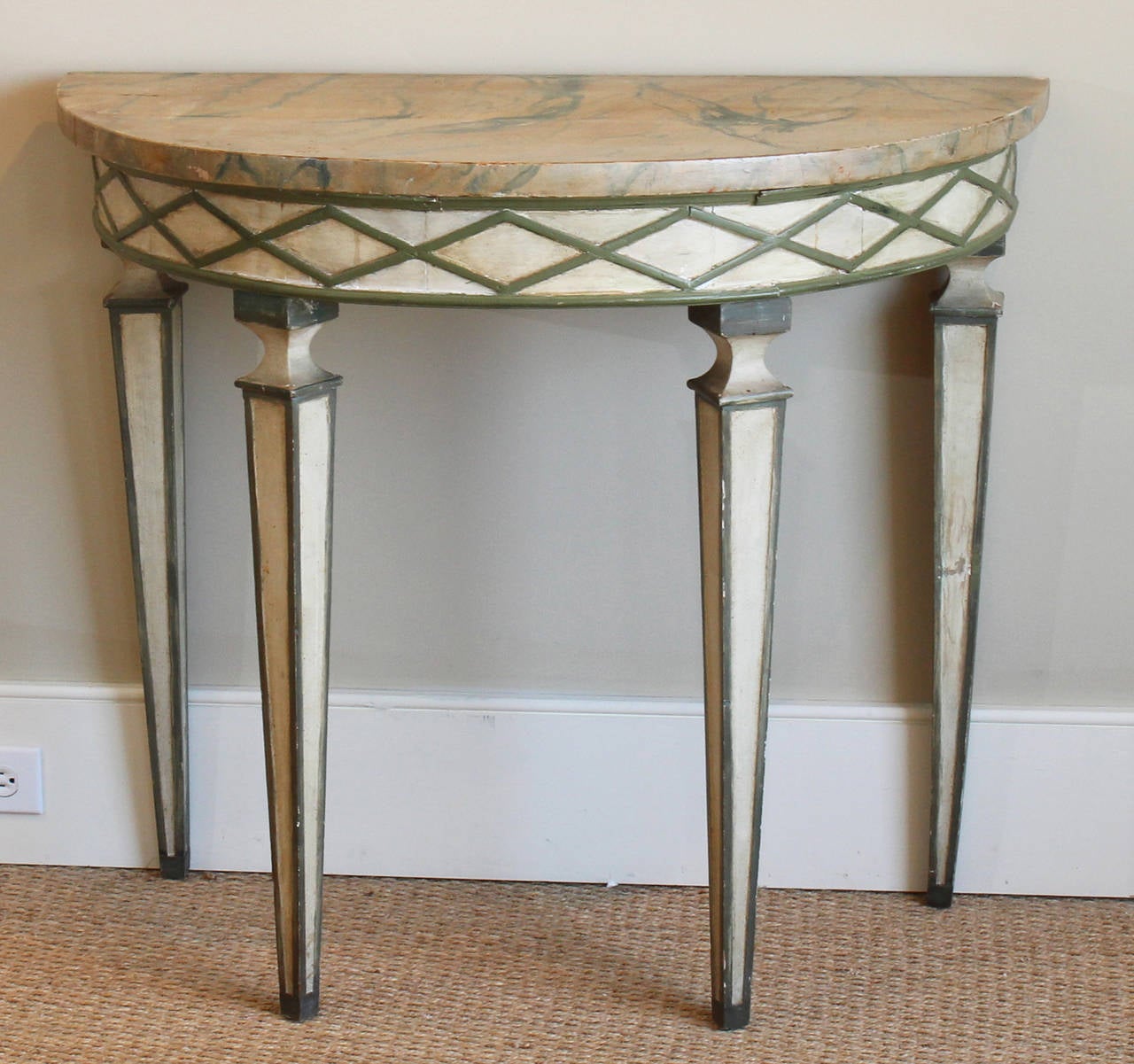 A charming early 20th century Italian faux marble and paint decorated demi-lune console table.