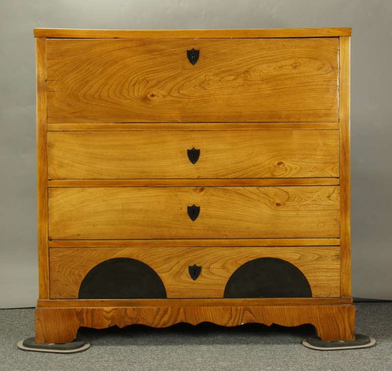 A solid wood four drawer Biedermeier chest, the top most drawer pulling out to reveal a hinged writing surface and 13 drawers and compartments with ivory pulls and escutcheons.