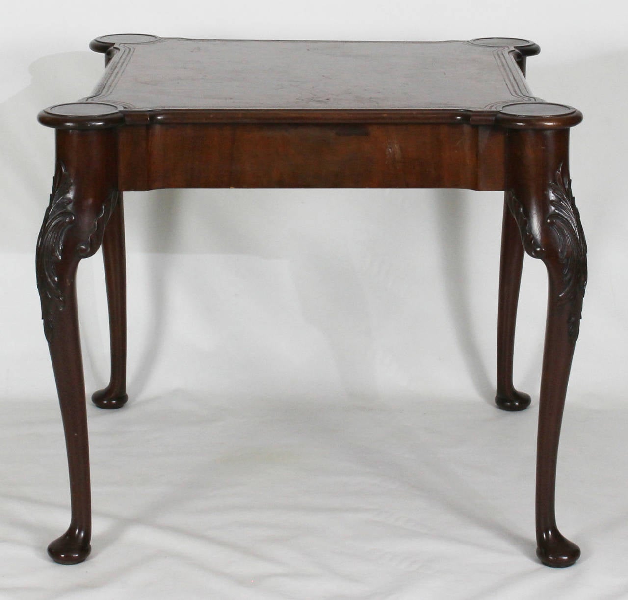 An early 20th century mahogany Georgian style card table with inset tooled leather top on cabriole legs and pad feet.