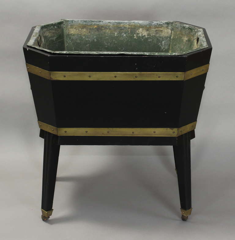 A charming ebonized wood and brass bound wine cooler with zinc liner dating from the 1940's