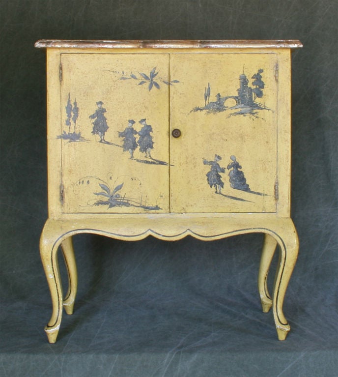 A charming small scale hand painted cabinet in a rich yellow ground with figures in a garden setting.
