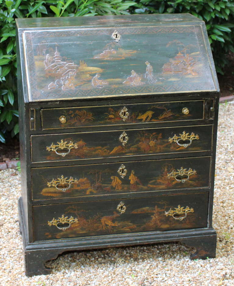 An English mid 19th century George III style secretary desk in an unusual green lacquer with chinoiserie decoration.
