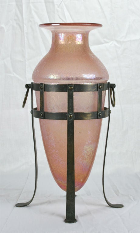 A large pink Scavo glass amphora vase resting on a fitted bronze stand with lovely old patina