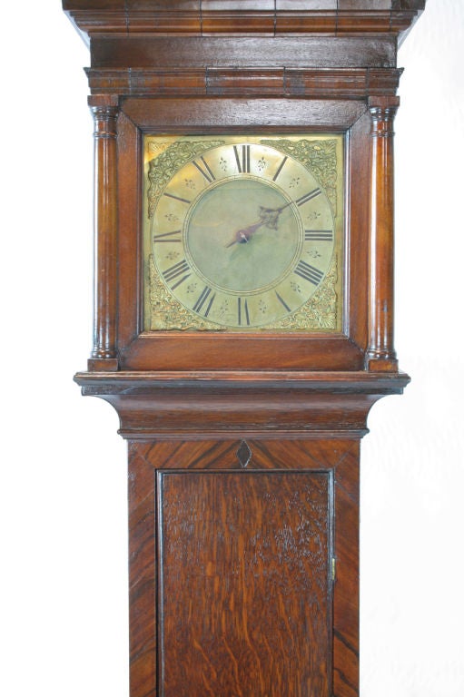 A very charming early-18th century oak tall case clock by John Worsfold of Dorking. A single hand time and strike with a 30 hour continuous chain movement, early anchor escapement, single weight, and square brass dial. The clock is inlayed on the