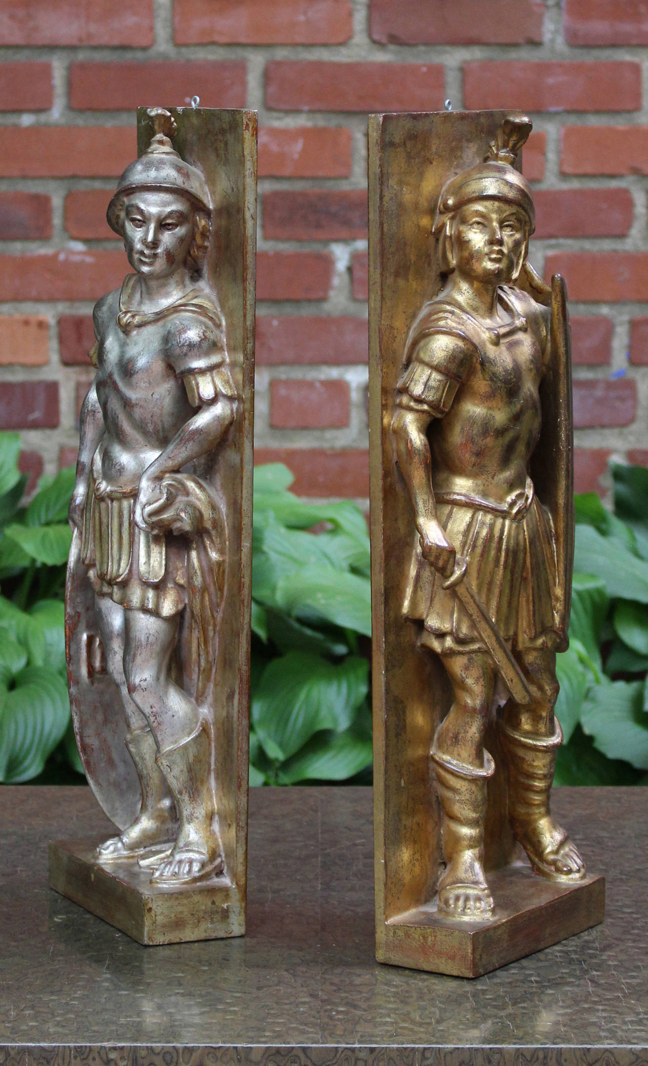 A pair of silver and gold gilt decorated plaques depicting Roman soldiers, circa 1960, stamped 