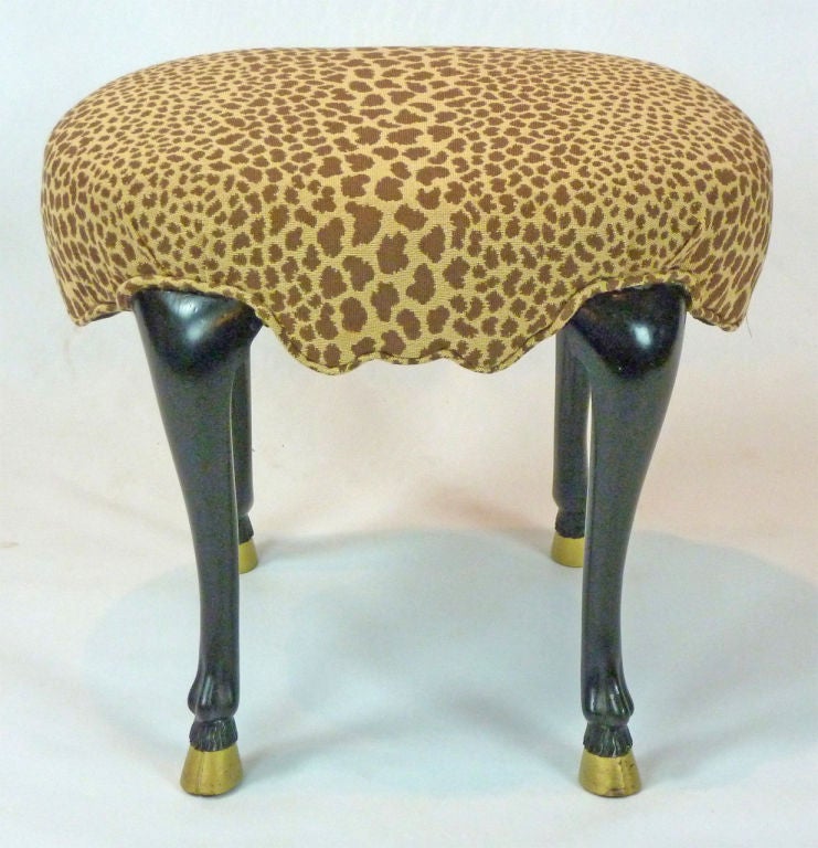 A delightful carved and ebonized animal legged footstool recently covered in a needlepoint leopard print fabric.