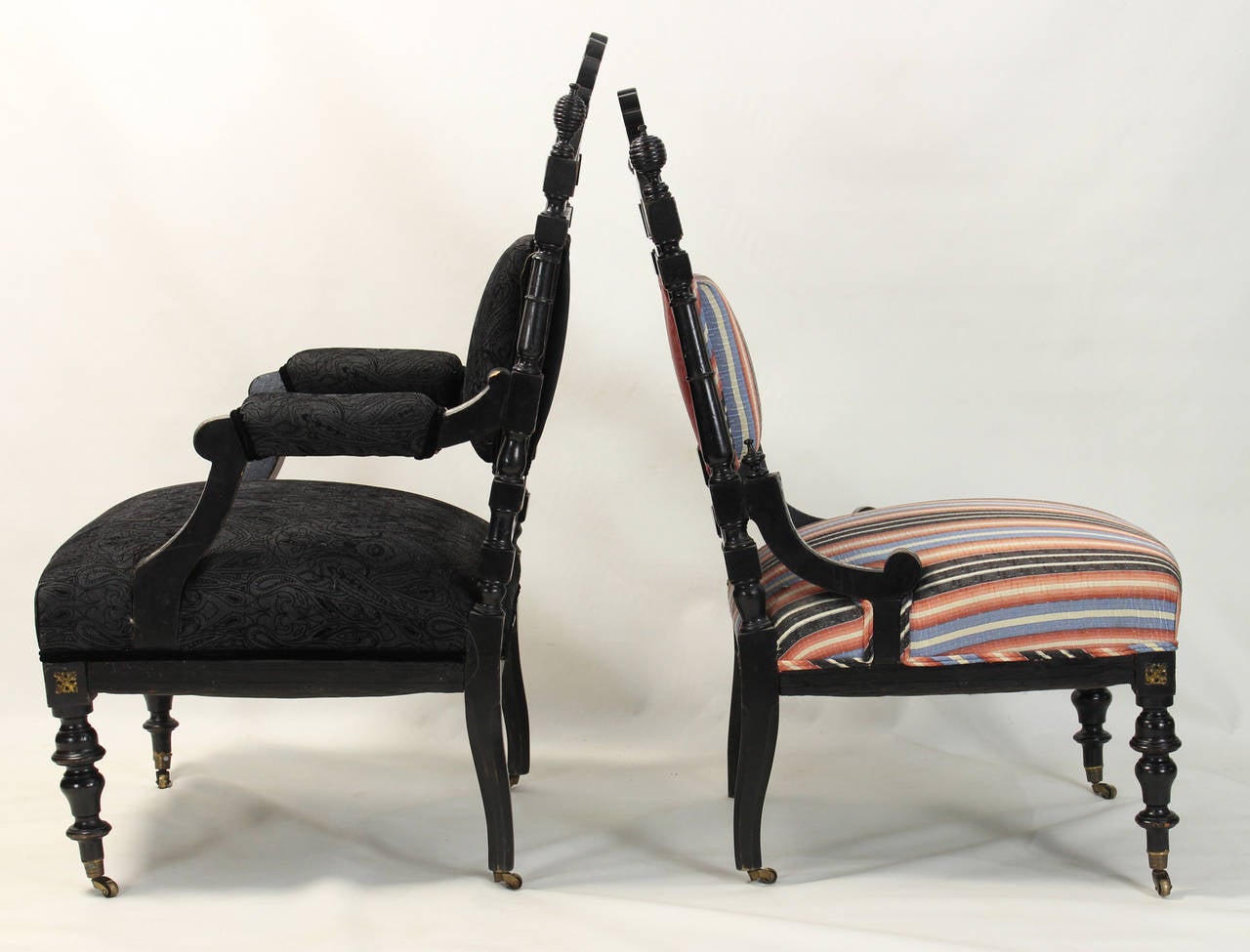 An unusual pair of English Victorian Parlor chairs dating from the 1870s in black lacquer accented with extensive mother-of-pearl decoration.