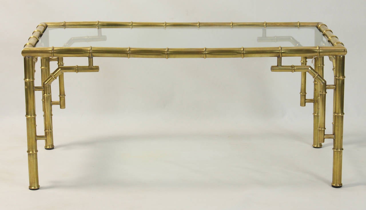 A mid-20th century Italian solid brass faux bamboo cocktail table inset with glass top.