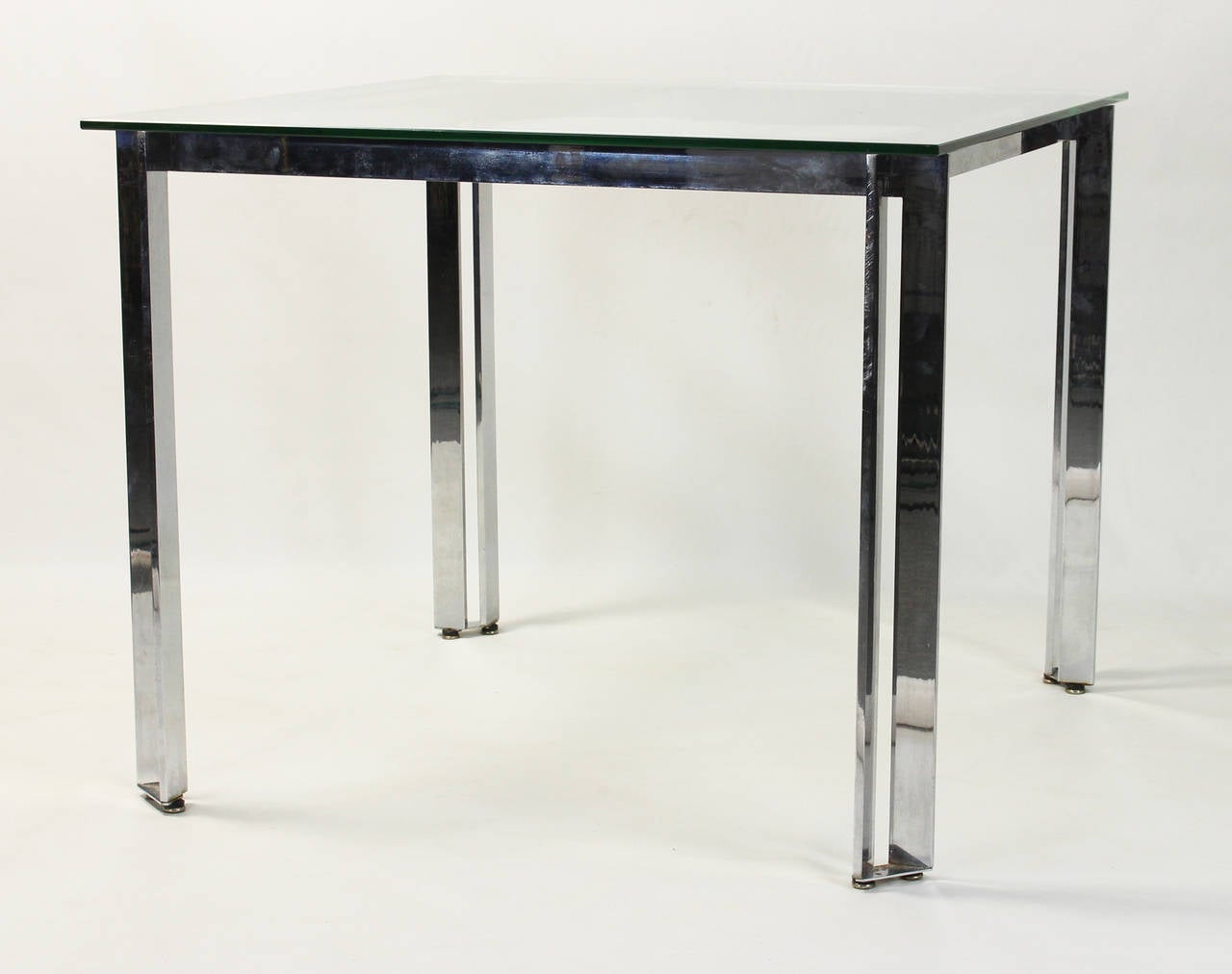 A mid-20th century chrome and glass square breakfast or games table.