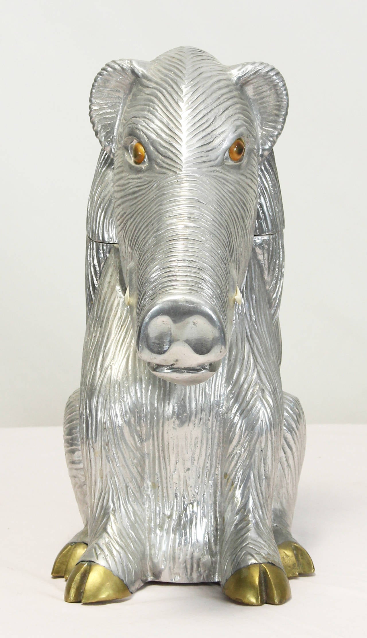 A whimsical and very charming warthog wine cooler in cast aluminum with glass eyes, bakelite tusks and brass feet.
