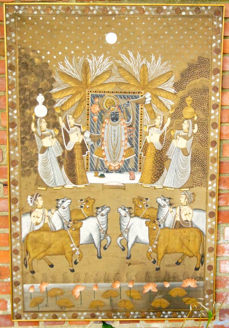 A large Indian silk painting depicting a Hindu god and attending maidens with sacred cattle in the foreground.