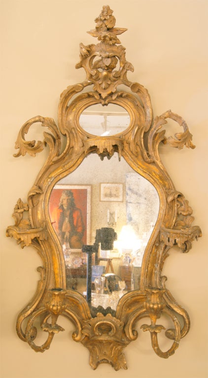 An exuberant Venetian girandole gilded mirror with open foliate and Chinoiserie carving and its original glass.