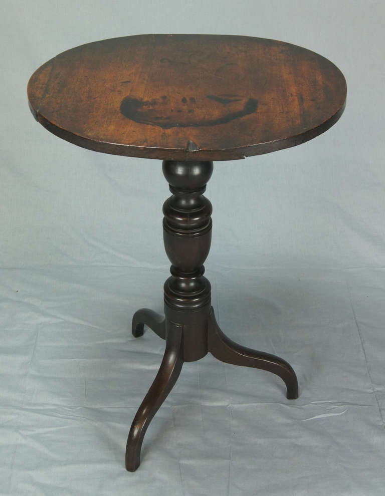 An early 19th century carved walnut candle stand table. This table was in the Governor's Mansion in Richmond, Virginia during Governor Pollard's time in office in the 1930's. The old label on the back indicates that it was made in King & Queen
