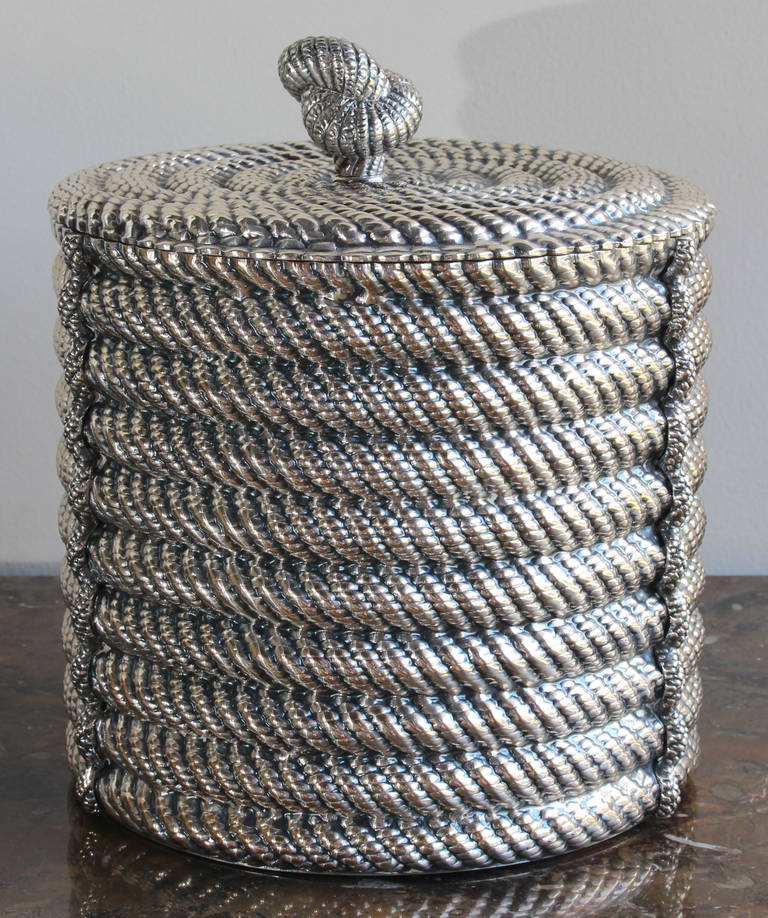 A large silverplate ice bucket in the form of coiled rope by Spanish designer Valenti.