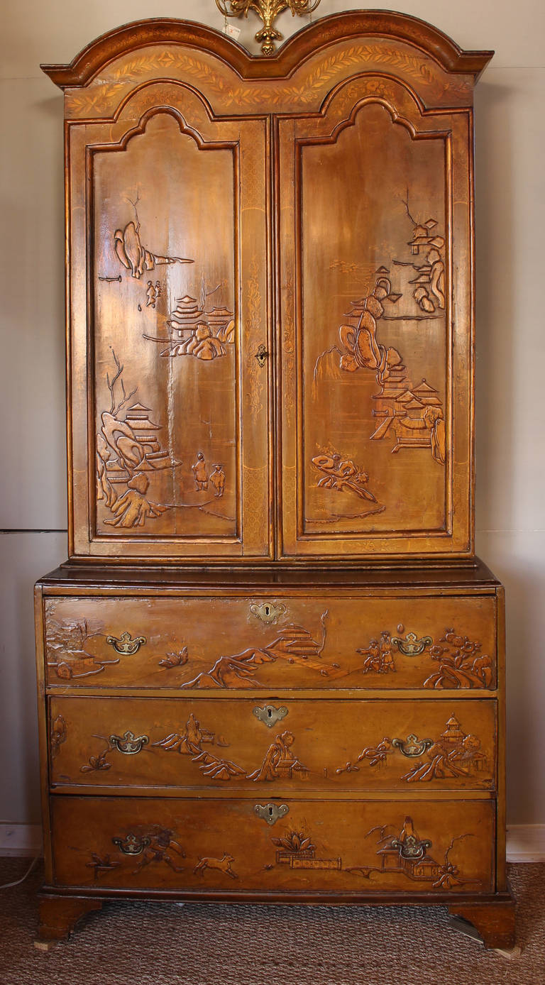 An early 19th century English blind door bureau bookcase in saffron yellow with raised chinoiserie decoration.