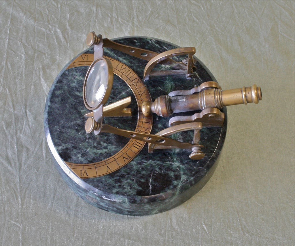 A horizontal cannon sundial made of marble with brass fittings and maintaining its original powder horn. Priming the cannon with powder and setting the lens to the correct angle for the noonday altitude of the sun, the concentrated rays of the sun