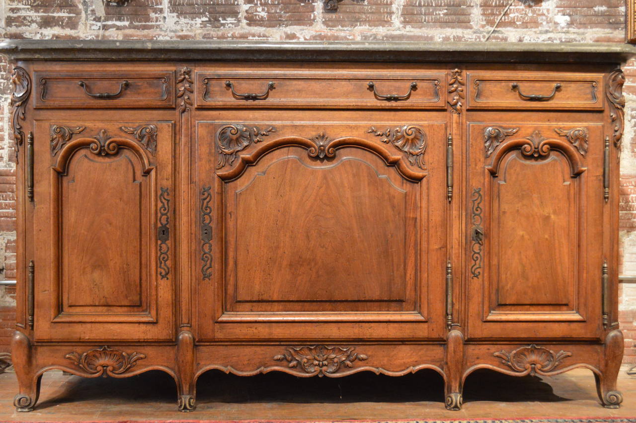 19th century Louis XV style walnut enfilade from the Rhone valley with well sculpted elements, exceptional massive marble top with undercut cove, three drawers over three doors, molded paneled doors.