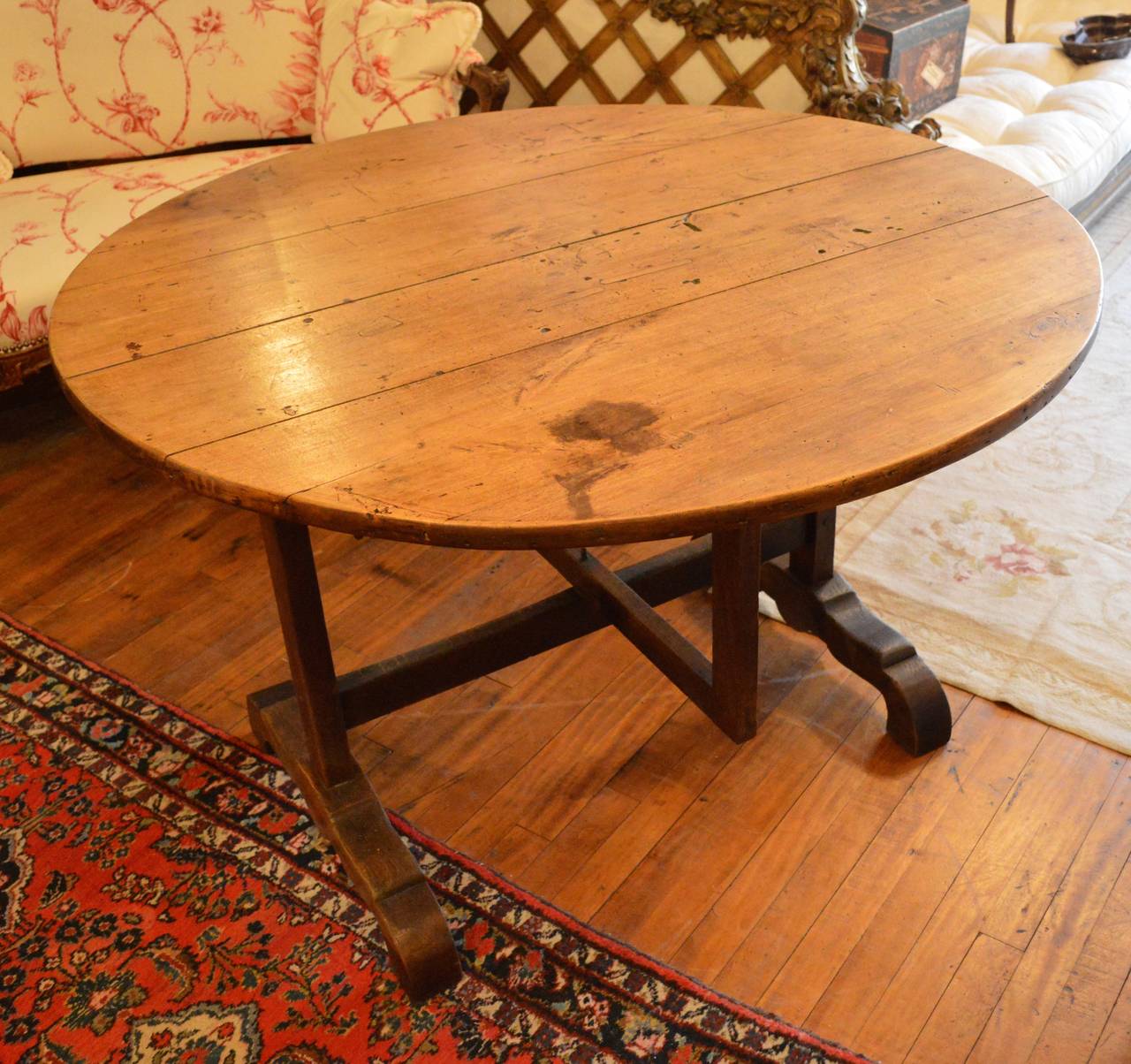 A 19th century French Provincial tilt-top wine tasting table on square pivoting trestle base, four board beechwood plank top.
