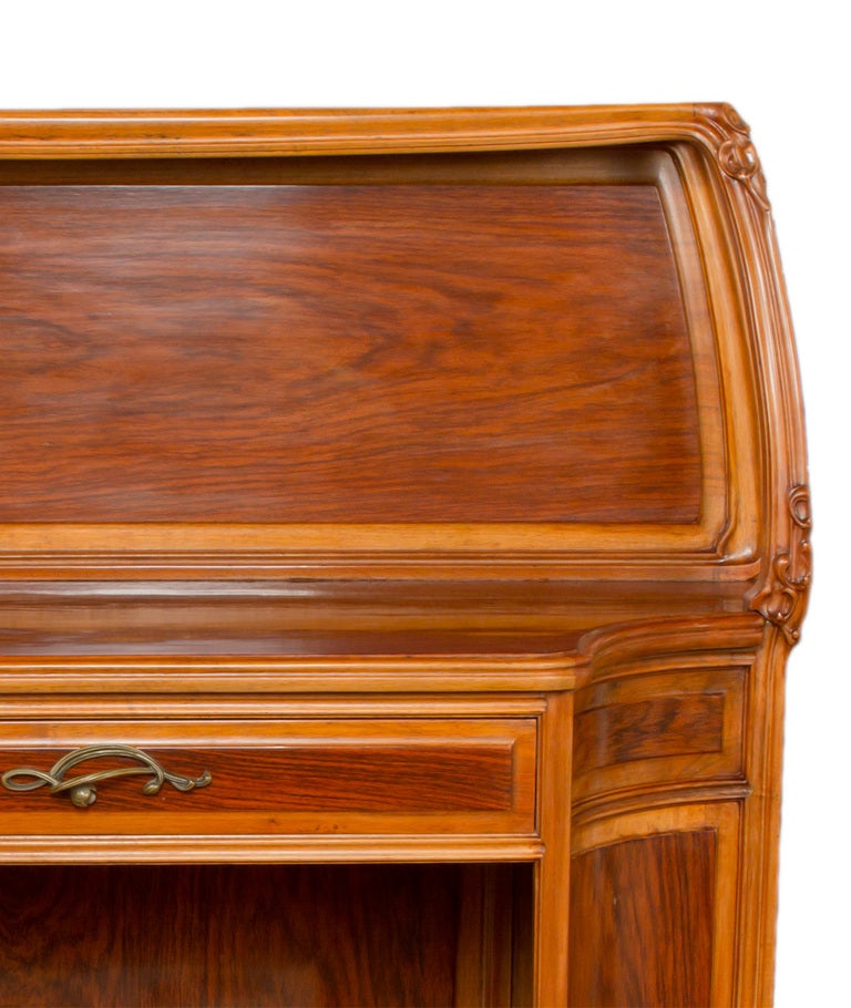 French Art Nouveau carved mahogany and bronze server by, Louis Majorelle decorated with fully carved floral rails, exotic fruitwood marquetry door with flowering water lillies and further decorated with an original gilt bronze stylized acorn