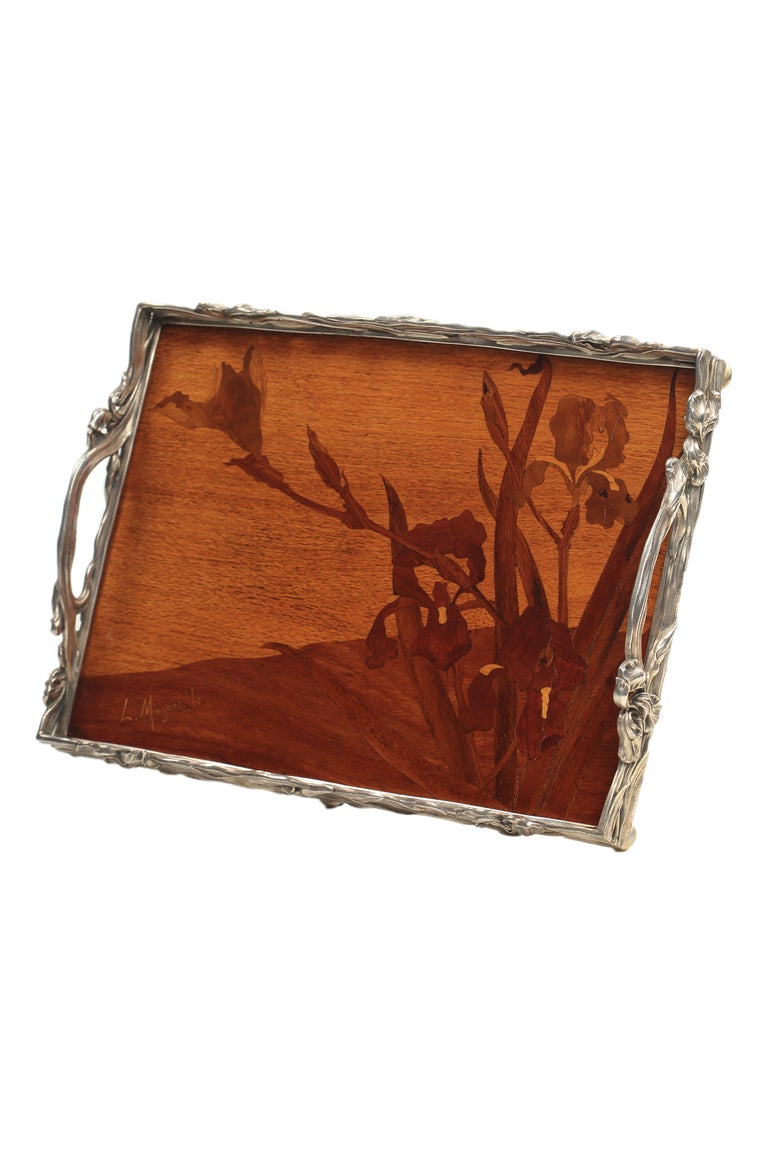 A French Art Nouveau wood and silver marquetry tray by, Louis Majorelle decorated with various fruitwood inlaid marquetry iris decoration set with in a sterling silver iris pattern frame. The tray is signed, 
