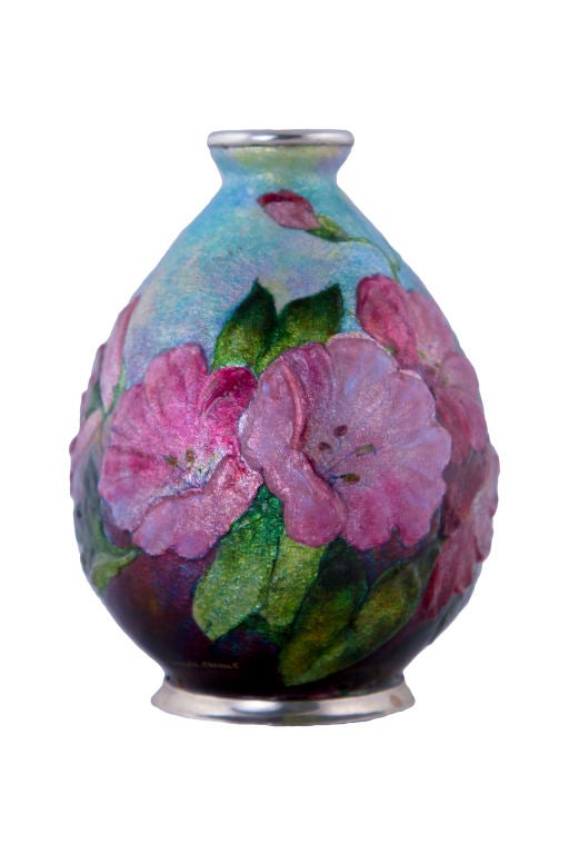 A French Art Nouveau enameled laid over copper vase by, Camille Fauré decorated with all over flora and leafage against a sky blue background. The vase is signed, 