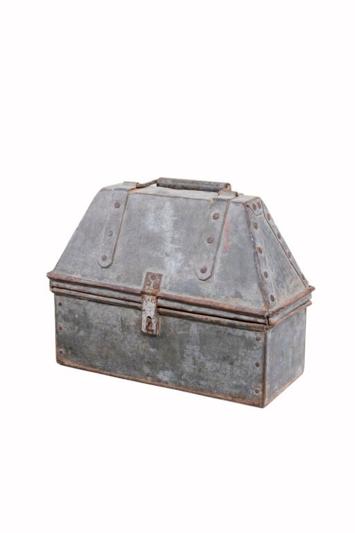 An early American industrial hand crafted tool box made out of sheet metal and  galvanized cold riveted and a wire edge. A true piece of American Industrial craftsmanship.