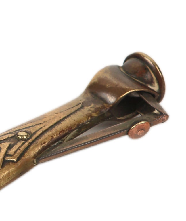 An extremely fine and very rare patinated bronze cigar cutter by, Tiffany Studios decorated in an aztec like pattern. The cigar cutter is signed, 