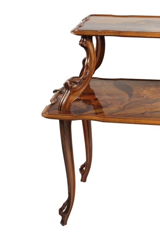 An extremely rare and important French Art Nouveau tea table by, Emile Gallé decorated with inlaid exotic wood marquetry depicting various flora with beautifully carved organic legs embellished with beautiful leaf decoration and further decorated