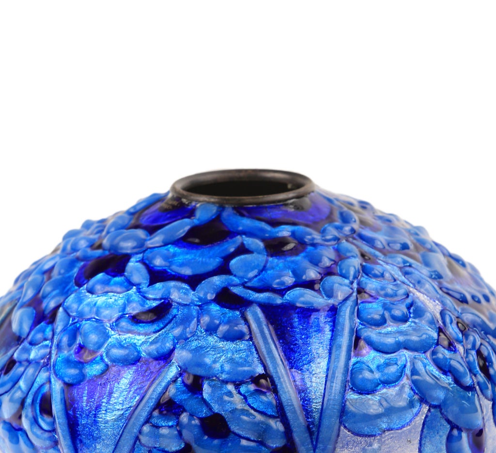 An enamel on copper Stylized Geometric vase by, Camille Faure decorated with all over highly stylized blue flowers and geometric pattern throughout. The vase is signed, C. Faure.

circa 1935