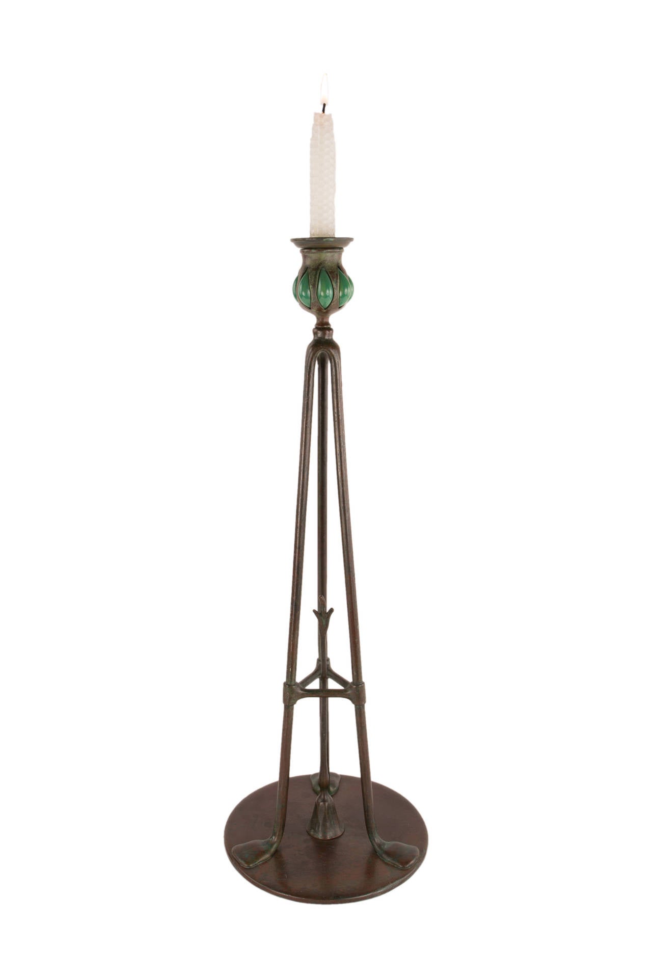 A fine and rare American Art Nouveau patinated bronze and glass candlestick decorated with green glass blown out candleholder a top a three legged tripod form a top a circular platform further decorated with snuffer set in the center decorated as a