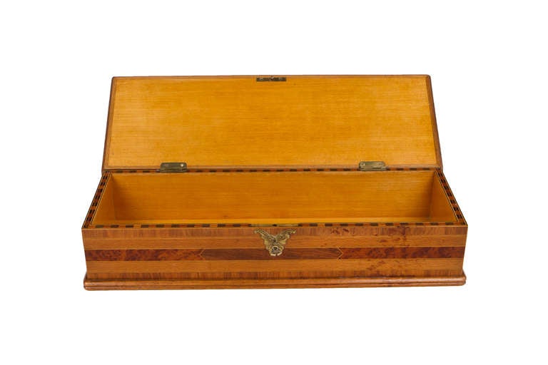 A French Art Nouveau lidded box with various exotic wood and marquetry decoration in a foliate motif by Emile Gallé. The box is decorated with intricate marquetry work and further decorated with bronze butterfly escutcheon and retains its original