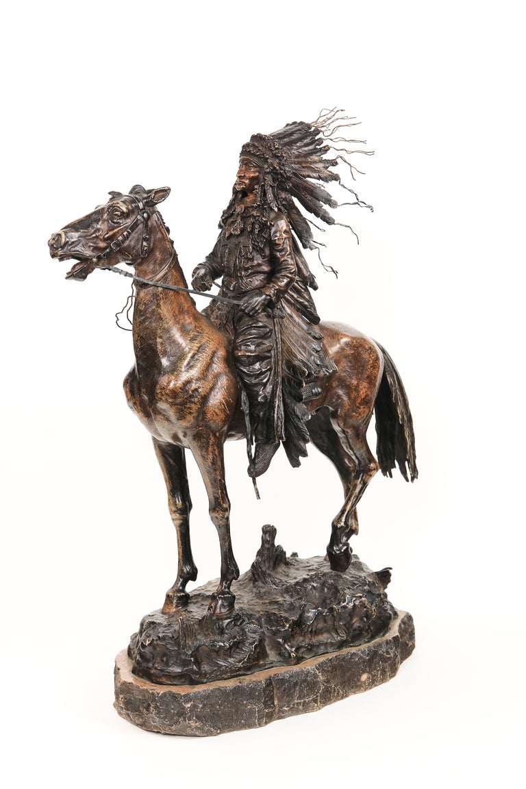 An impressive Austrian Art Nouveau patinated bronze sculpture Indian Chief on Horseback by, Carl Kauba of a Native American Indian Chief sitting a top a horse on its original petrified stone base. The sculpture is signed, 