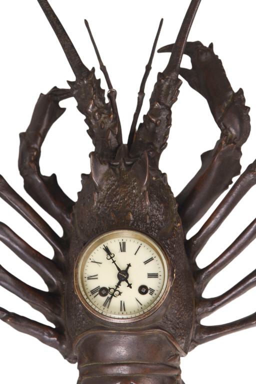 A monumental European patinated bronze wall clock cast as a Lobster with its original movement located in the center of the lobster. The lobster is unsigned and guaranteed to be a period clock from the early 20th Century. circa 1900.