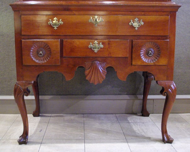 Philadelphia area, Pennsylvania or New Jersey, ca. 1745

This remarkable high chest-of-drawers is perhaps one of the most elaborate and fully developed Queen Anne examples madein the Delaware Valley. With its suprebly carved shells and sunflowers,
