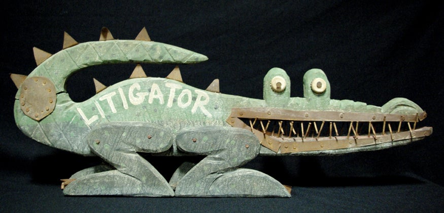 Carved and Painted Aliigator

Green painted and carved wooden alligator with metal and nail embellishments, entitled, 