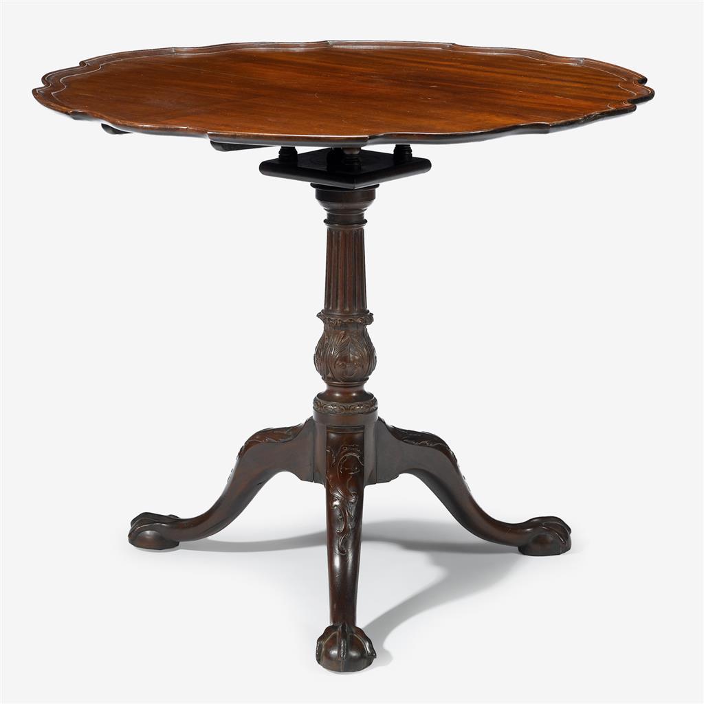 Chippendale carved mahogany pie crust tea table 
Pennsylvania, late 18th century 
The molded pie crust, single board top on fluted and carved urn form support on carved cabriole legs ending in ball-and-claw feet. 
H: 30 1/4 in. Diam: 35 1/2 in.