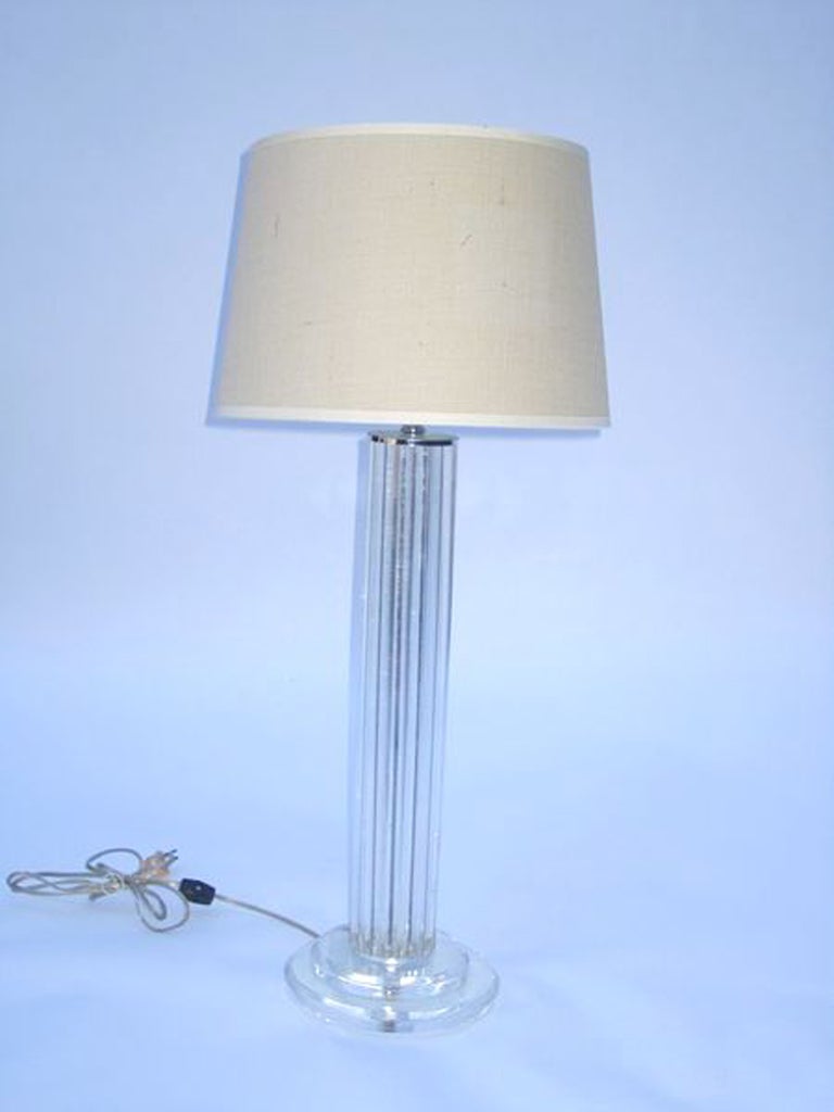 A single vintage table lamp with a body composed of clear lucite rods on a stacked clear lucite base. The piece is in good vintage condition with age appropriate wear; some scratches.

Reduced from $850.00