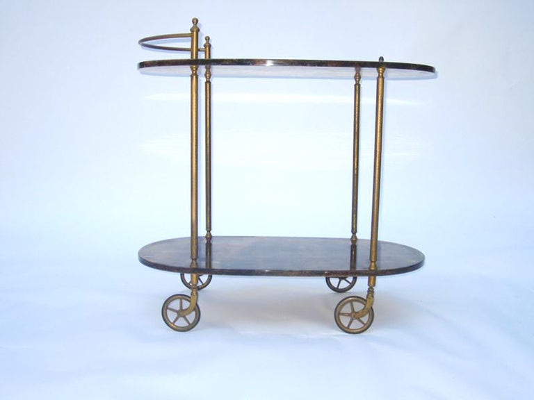 A vintage two-tier serving cart by noted mid century designer Aldo Tura. The piece has tortoise colored lacquered goatskin shelves and brass detailing. 

The piece is in good vintage condition with age appropriate wear; some scratches

Reduced