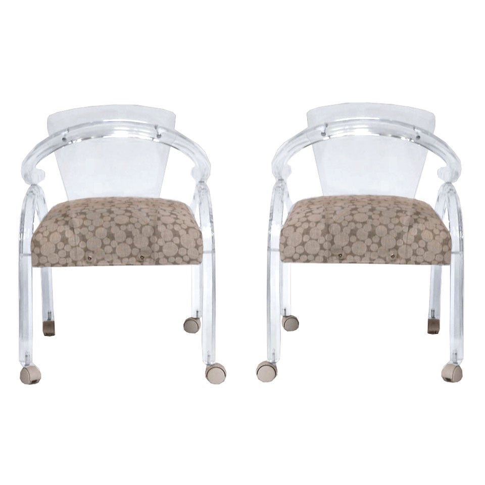 A Mid Century Pair of Lucite Armchairs on Casters