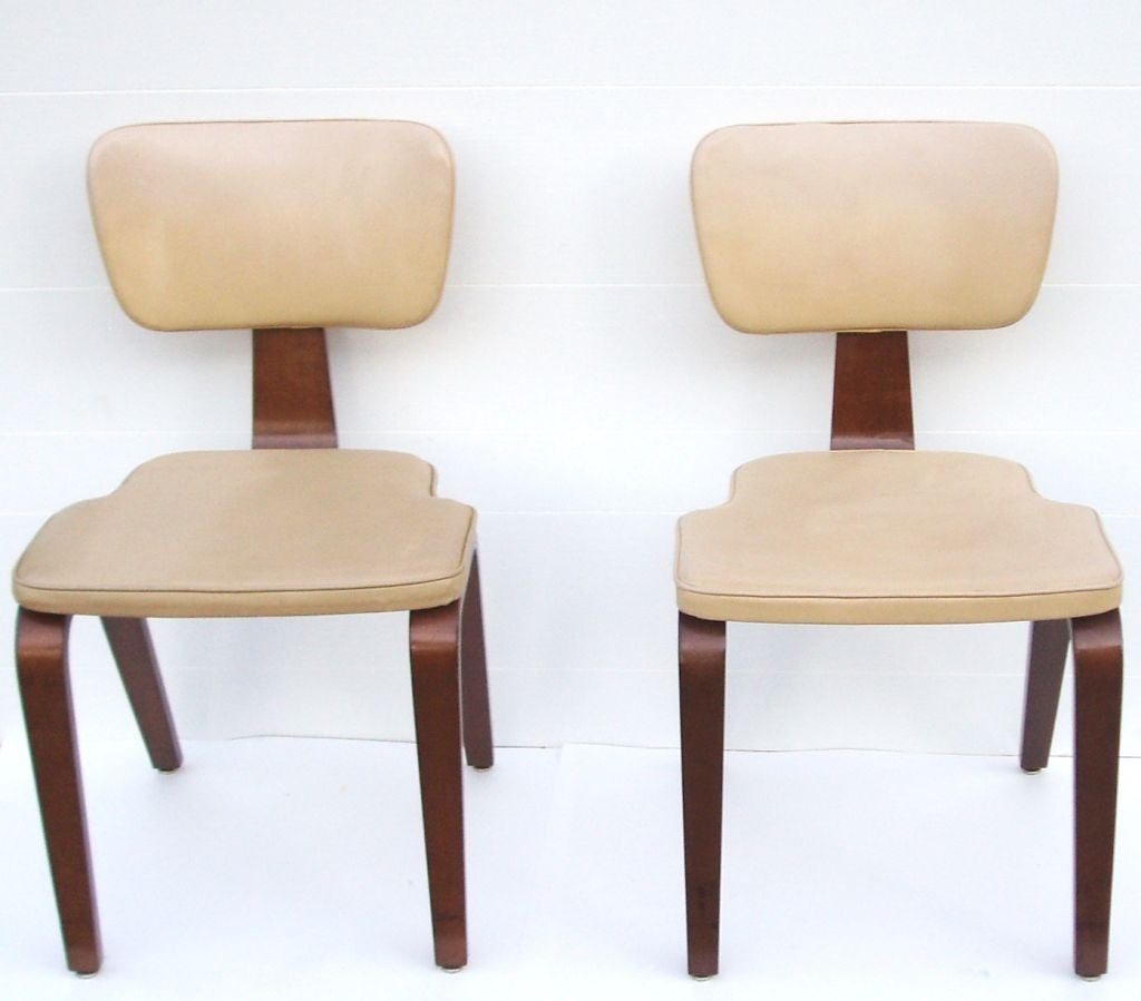 A pair of bentwood side chairs by Thonet upholstered in tan vinyl.<br />
<br />
Reduced From: $850