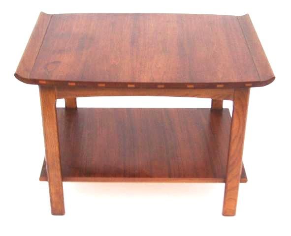 A vintage end table by Lane with a curved edge surface and a second shelf below.<br />
<br />
Reduced From: $550