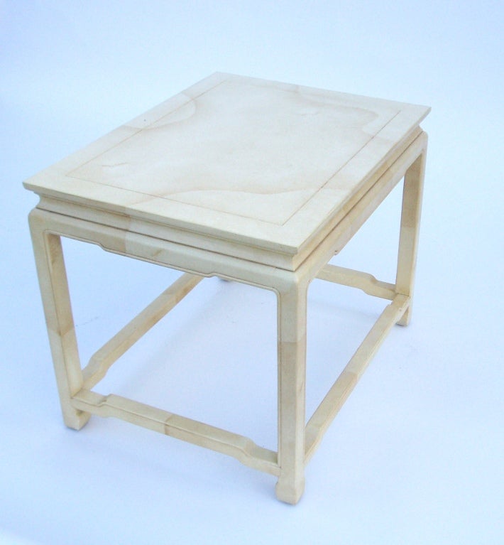 A pair of vintage side tables by Henredon in an off white faux-goatskin.