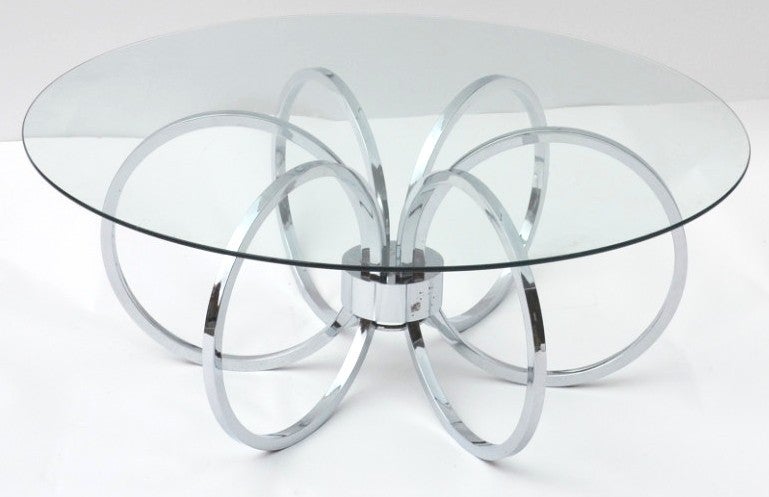 A vintage coffee or cocktail table with a circular chrome base and clear glass top.