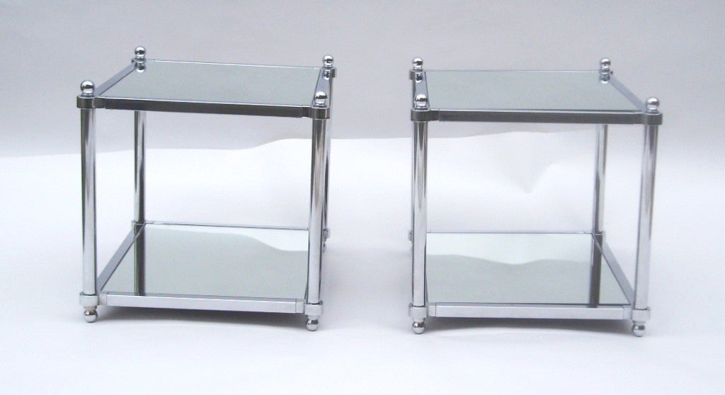 A pair of vintage side tables with chrome frames and two mirrored surfaces.

Reduced from $1250.00
