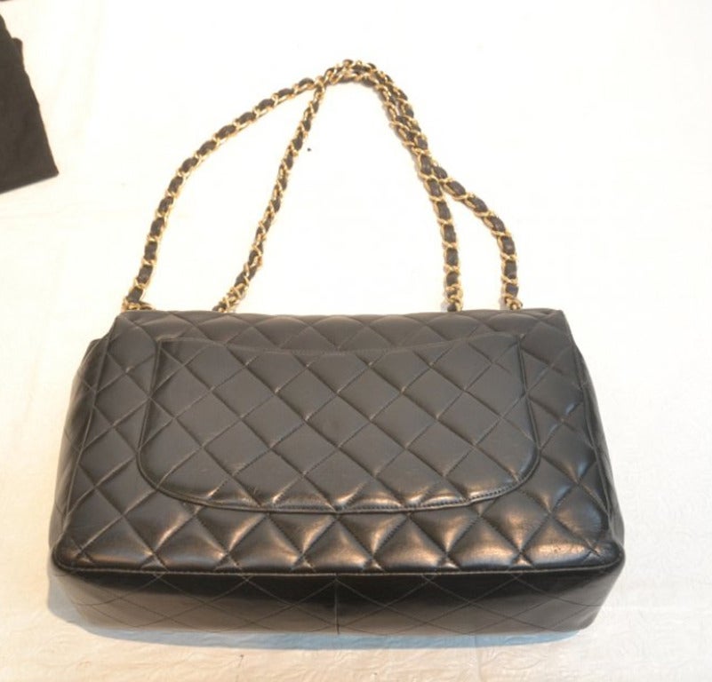 Quilted Authentic Chanel Black Classic Lambskin Maxi Handbag with Gold Tone Hardware