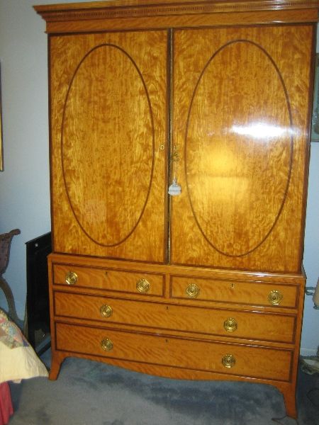 Georgian satinwood linen press with mahogany inlay design. Four drawers on the bottom part and six pull out shelves. Original brass hardware.<br />
<br />
Reduced From $14,500
