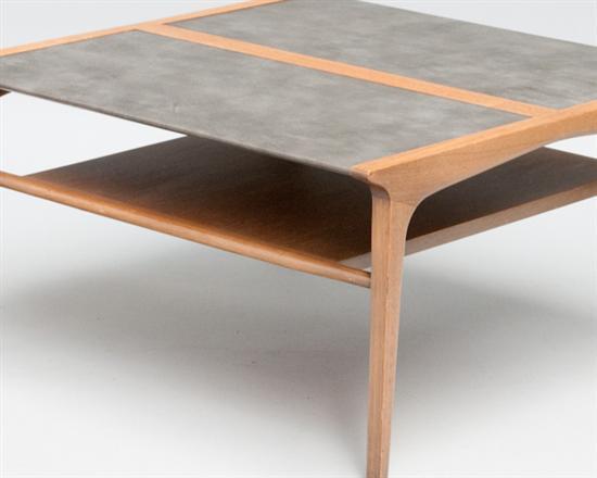 A vintage coffee or cocktail table from the Drexel Profile Collection by John Van Koert. The piece has two tiers with the top wrapped in grey leather

Reduced from $750