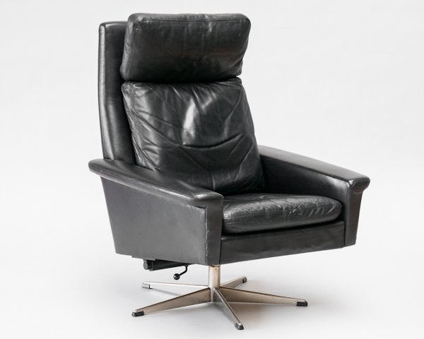 A vintage black leather lounge chair with a five-pointed swivel base. The piece is in good vintage condition with age appropriate wear; some scratches.

Reduced from $3450.00