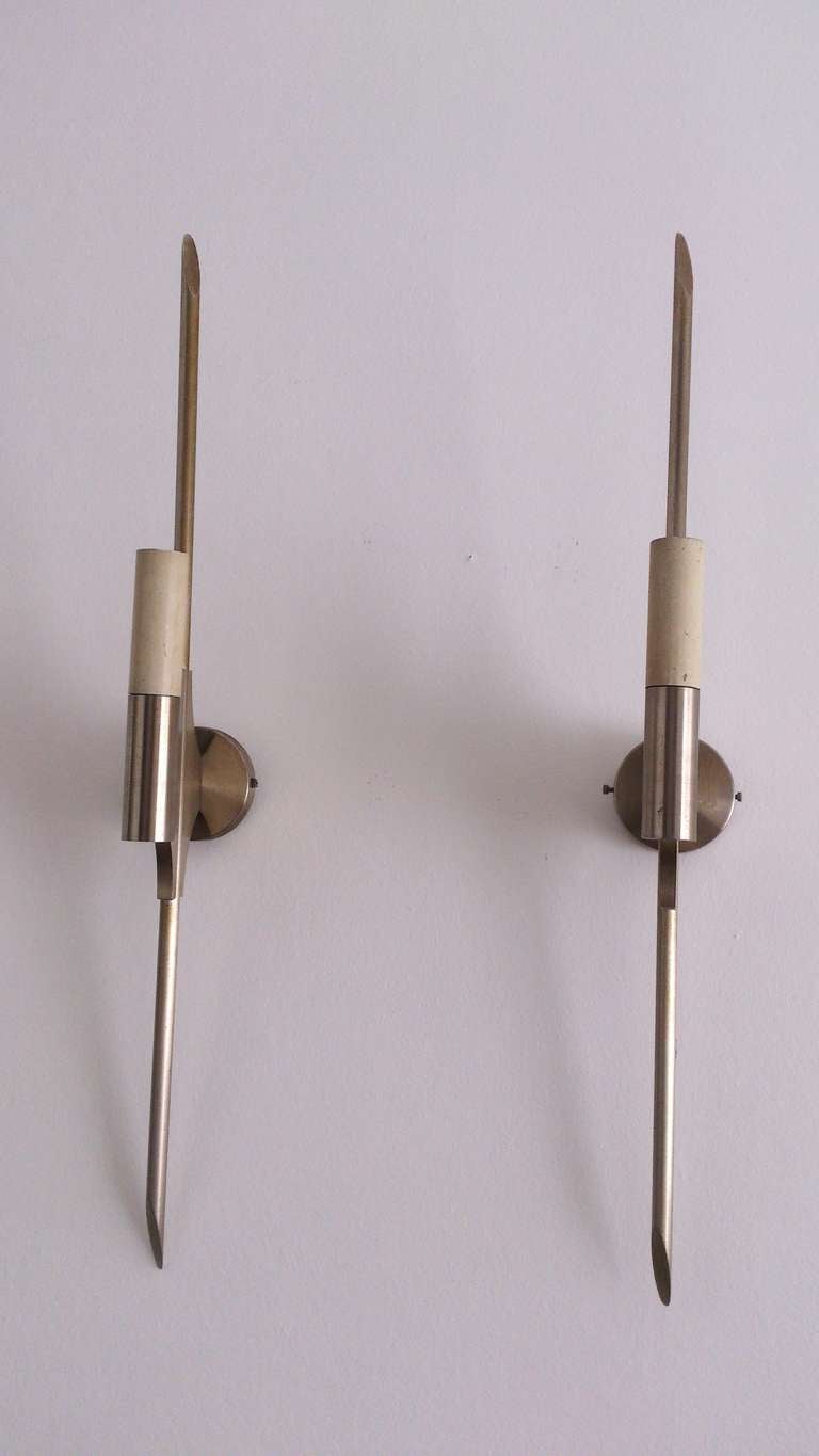 A pair of vintage Italian modernist wall sconces in brushed steel. They are in good vintage condition with age appropriate patina.
European sockets and wiring